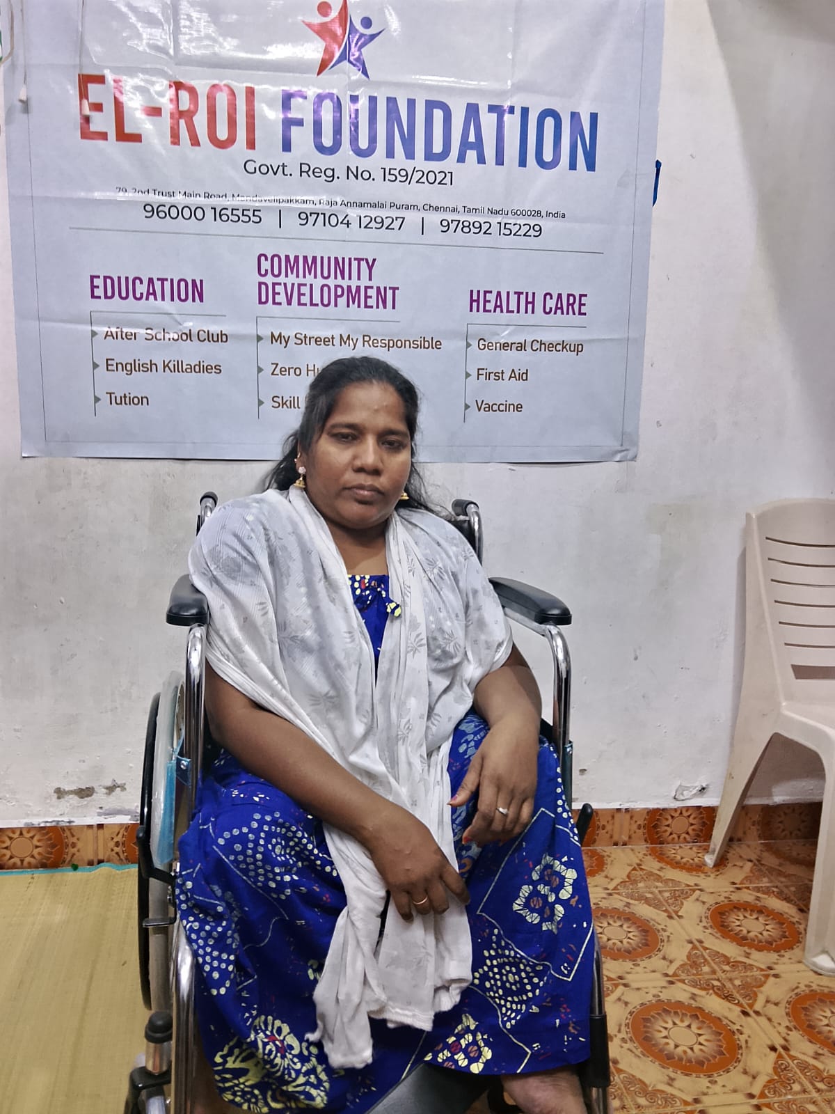 El-Roi Foundation representative in front of foundation banner